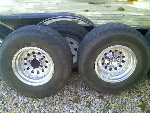 1996 Ford Bronco - Aftermarket wheels and tires are shown on a trailer, ready for transport.