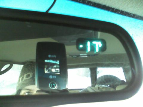 2000 Chevrolet Tahoe - Reflection in the rearview mirror shows a cell phone and a digital thermometer indicating 17 degrees.