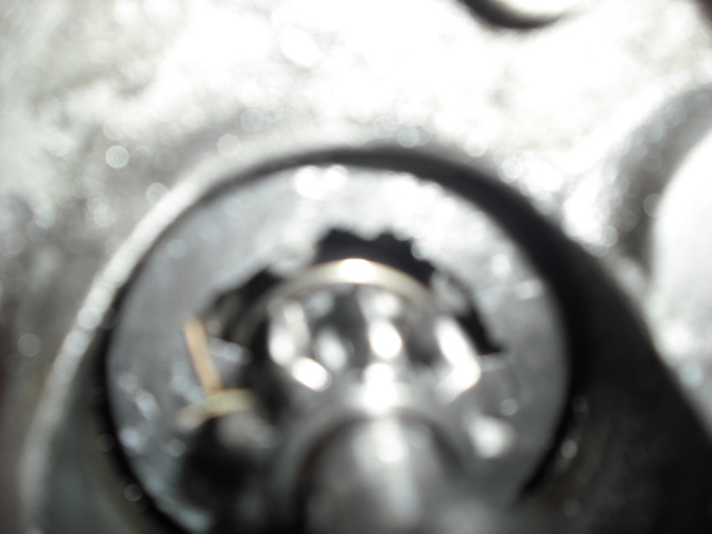Close-up of a damaged metal component with visible teeth and a ring