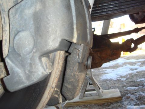 1978 Chevrolet C/K Pickup - Detail view of a vehicle's brake caliper and rotor, likely during maintenance or repair.