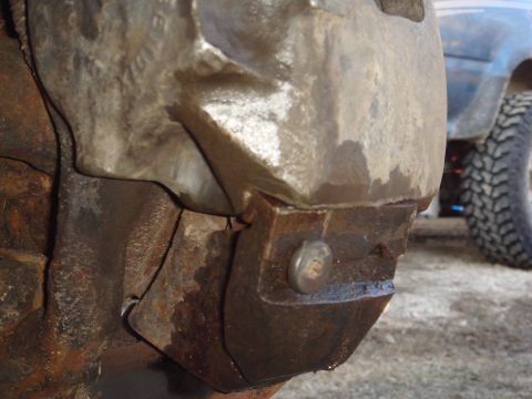 1978 Chevrolet C/K Pickup - This is a close-up of a heavy-duty axle housing, with a blue truck visible in the background.