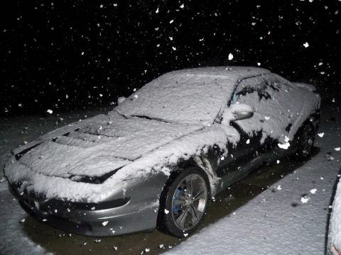 1995 Ford Probe - A 1995 Ford Probe is seen covered in snow during a winter storm.