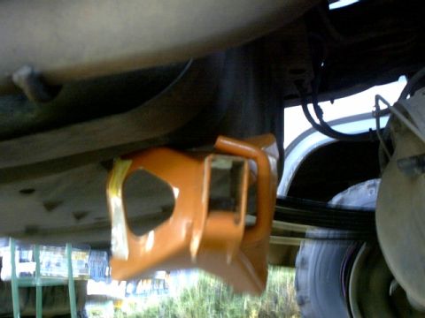 1995 Ford Bronco - Close-up of an orange tow hitch receiver mounted underneath a vehicle.