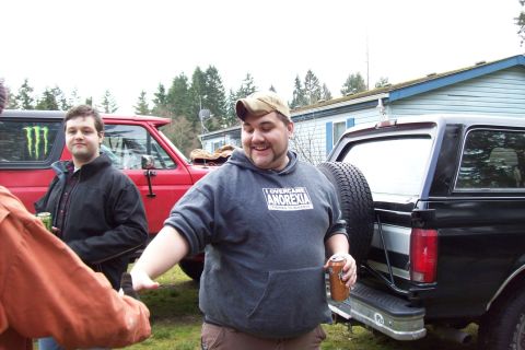 1995 Ford Bronco - Two men and a black SUV are seen outdoors, with a red SUV partially visible on the left.