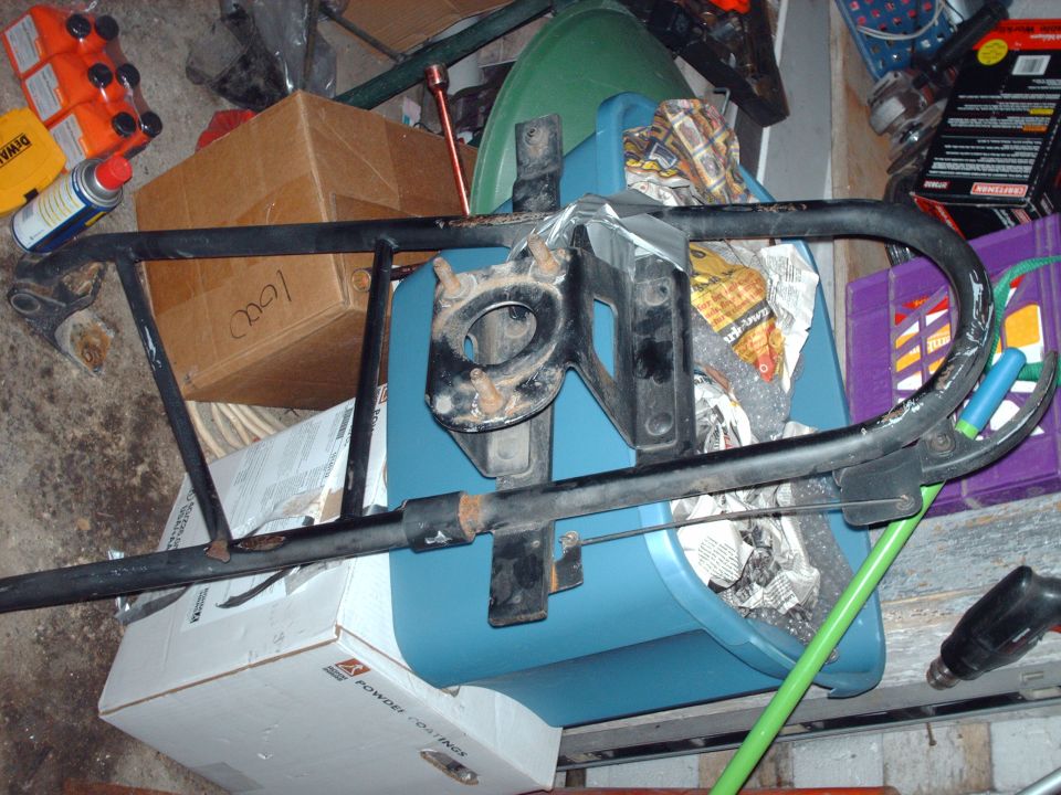 Black metal frame over boxes in a garage