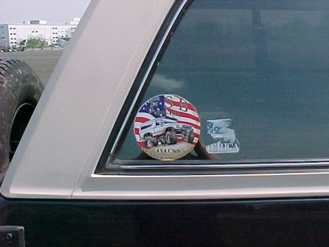 1993 Ford Bronco - Sticker on the window of a vehicle shows off-road vehicles and the American flag.
