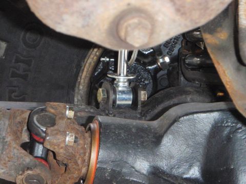 1996 Ford Bronco - A close-up view of the rear axle assembly of a 1996 Ford Bronco, showing the differential, driveshaft U-joint, and suspension components.