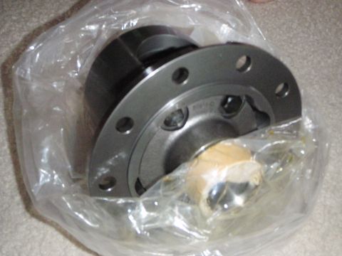 1996 Ford Bronco - A close-up view of a differential carrier, likely for a 1996 Ford Bronco, wrapped in clear plastic packaging. The metal part has several bo…