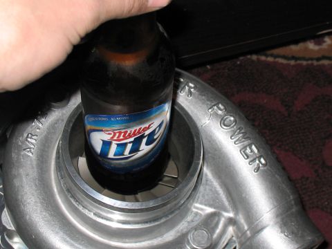 2001 Pontiac Trans Am - A hand holds a beer bottle with a visible label.