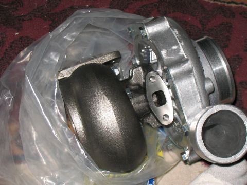 2001 Pontiac Trans Am - A close-up view of a turbocharger component, appearing to be new and in protective packaging.