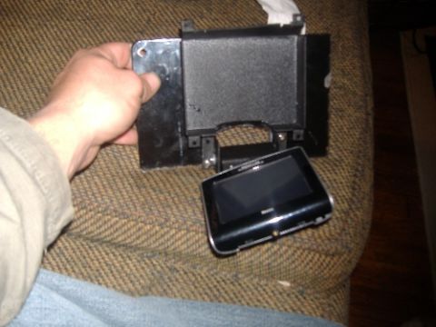 1997 Ford Crown Victoria - A person is holding a Nintendo DS Lite with a game cartridge next to it.
