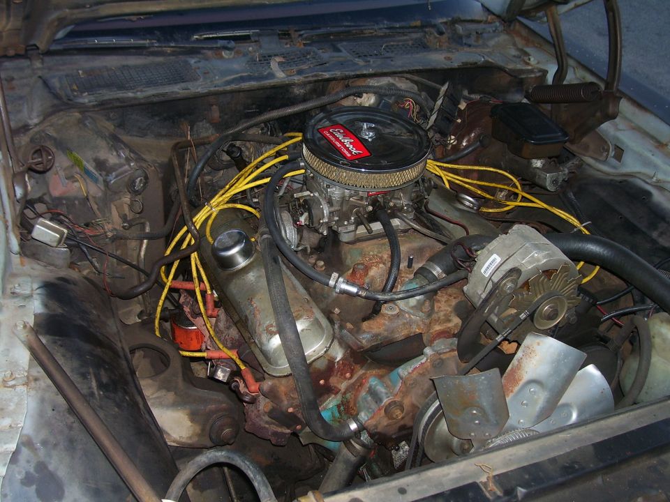 1978 Pontiac Trans Am engine bay with V8, chrome air cleaner, yellow wires, alternator, and rust.
