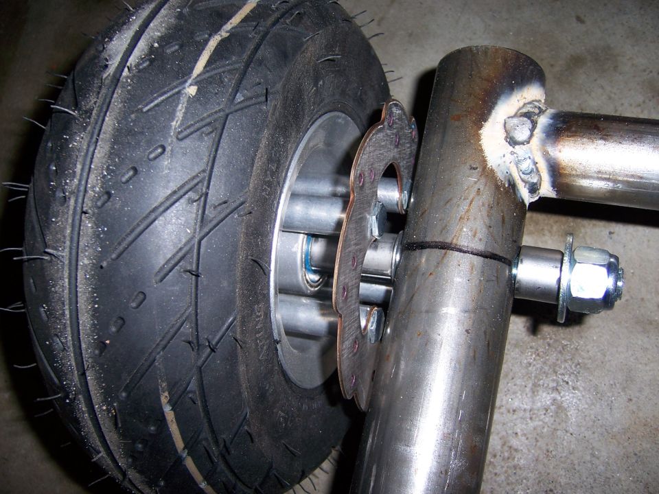 Photo of a small pneumatic wheel mounted on a welded steel axle hub