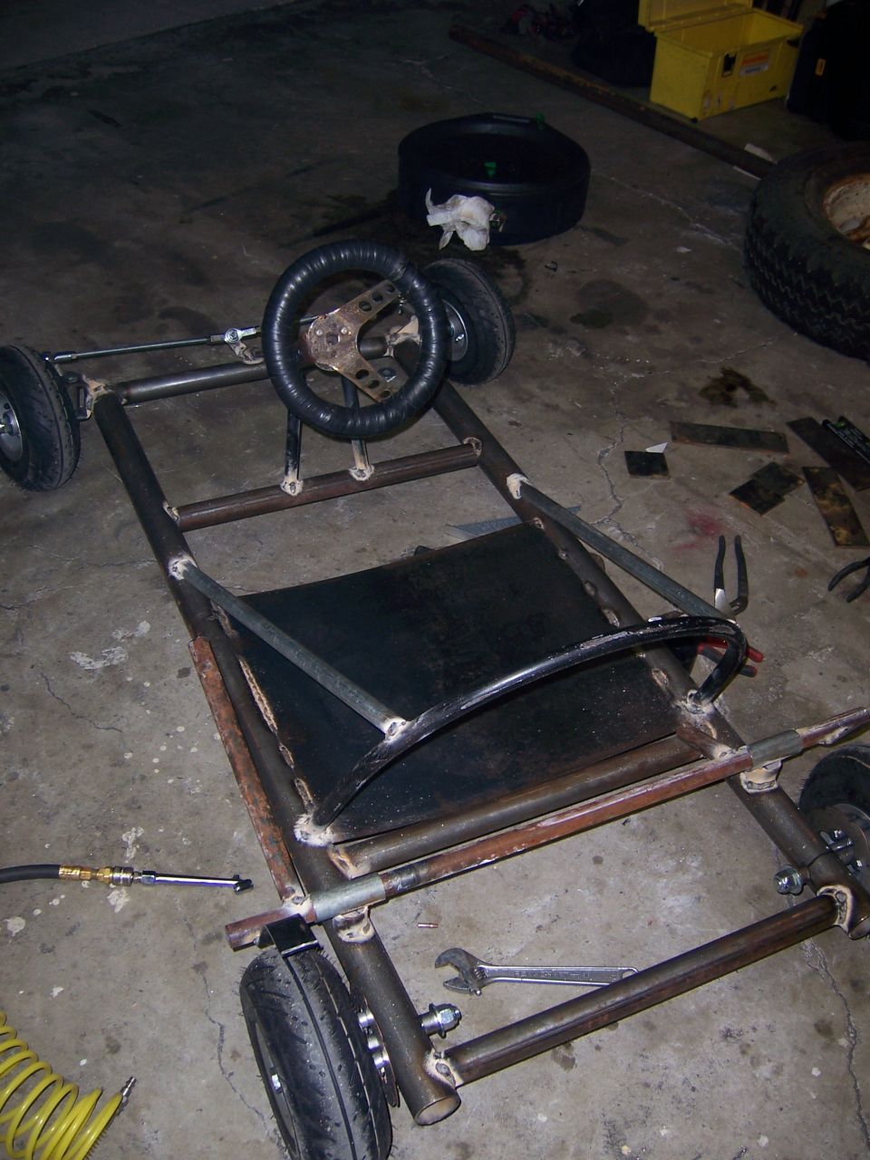 Photo of a go-kart frame with steering wheel and seat pan