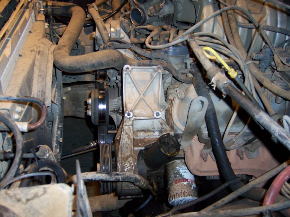 Photo of an engine with serpentine belt pulley and oil filter