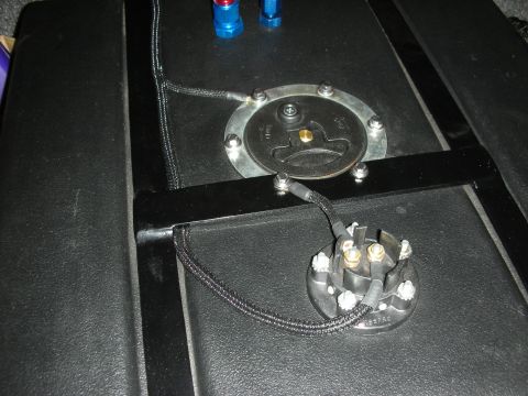 1992 Ford Crown Victoria - A close-up view of a fuel pump sending unit and associated wiring, likely installed in a vehicle's fuel tank. The components are mounted on…