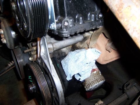 1991 Ford Bronco - A white label is affixed to a component within the engine compartment.