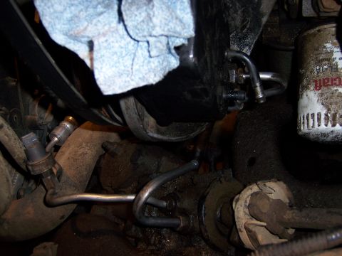 1991 Ford Bronco - Engine bay components including an oil filter and power steering lines are visible.