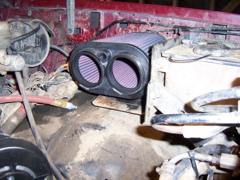1991 Ford Bronco - Close-up of a K&N dual air intake filter installed in a vehicle's engine compartment.