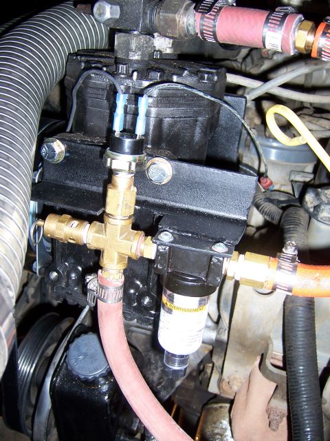 1991 Ford Bronco - Close-up view of engine components, including hoses, wiring, and a filter, with visible text on-screen text.