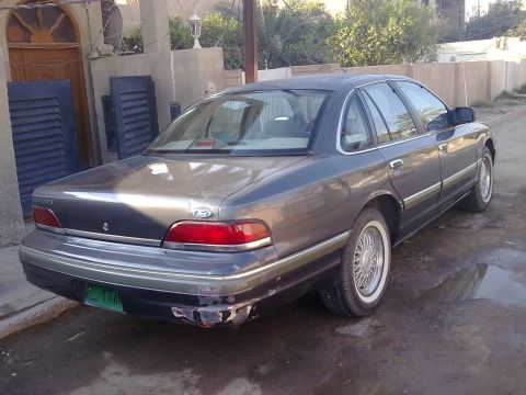 1992 Ford Crown Victoria - Rear 3/4 view of a 1992 Ford Crown Victoria sedan, showing its distinctive taillights and body style.