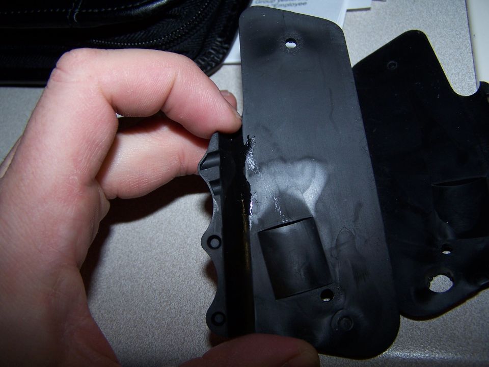 Black plastic part held by hand