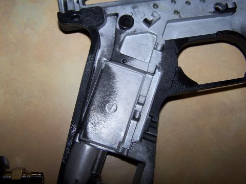 1986 Ford Bronco - Close-up of a gun frame, showing internal mechanisms and a two-tone finish.