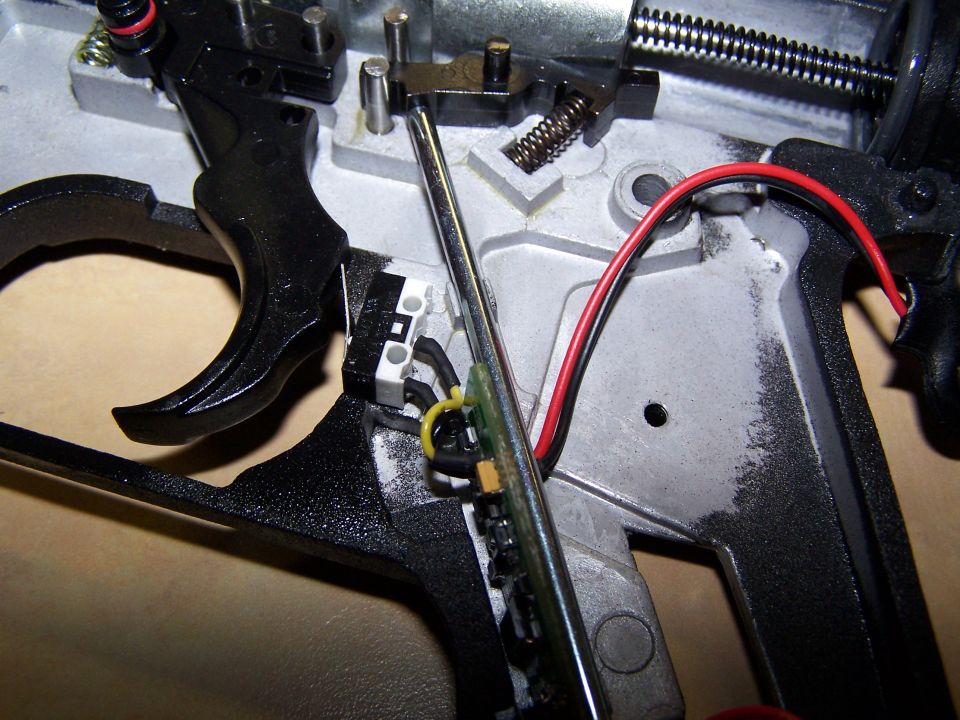 close-up of internal mechanism showing trigger, spring, and wiring