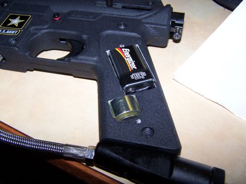 1986 Ford Bronco - A 9V Energizer battery is shown being installed in the grip of a U.S. Army branded paintball marker.
