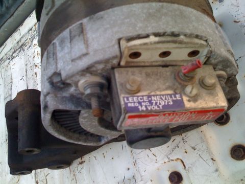 1984 Ford F-250 - Close-up of a Leece-Neville alternator, showing its model and voltage information, mounted on a vehicle.