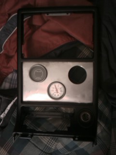 1987 Mazda RX-7 - Dashboard gauge cluster with a metallic faceplate and various gauges installed.