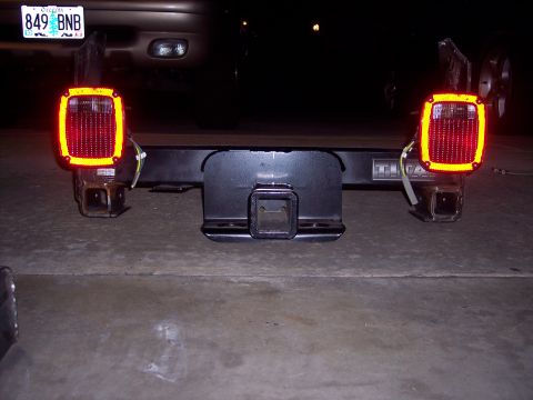 1981 Kenworth W900A - Aftermarket trailer lights mounted on a trailer hitch assembly. Vehicle's license plate is visible.