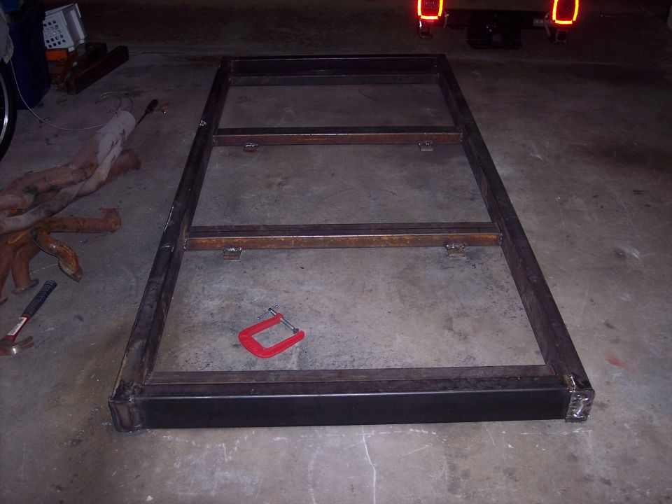 Metal frame with C-clamp on concrete floor