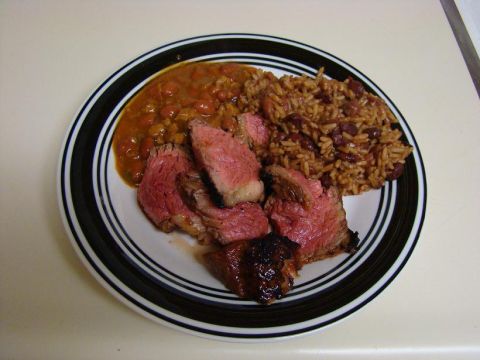 1989 Ford Bronco - A plate holds sliced roast beef next to rice and beans.