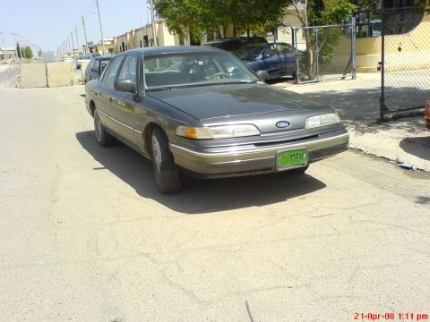 1992 Ford Crown Victoria - This 1992 Ford Crown Victoria is seen from the front in a gray sedan body style.