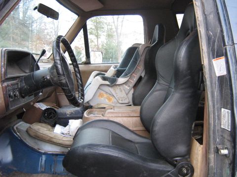 1990 Ford Bronco - The interior of this 1990 Ford Bronco features aftermarket bucket seats and a child safety seat.