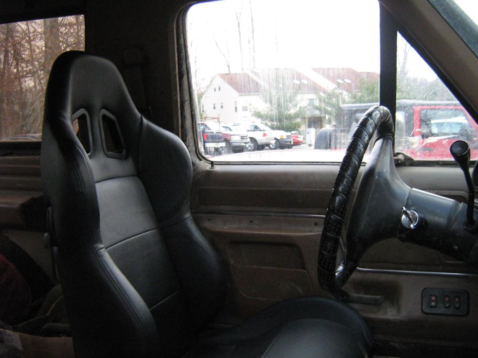 Interior view of a 1990 Ford Bronco with racing seats and steering wheel