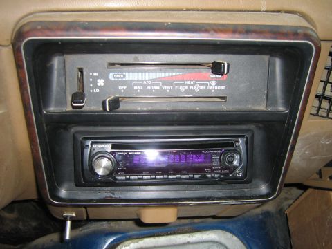 1990 Ford Bronco - Interior shot of climate controls and an aftermarket stereo unit in a vehicle.