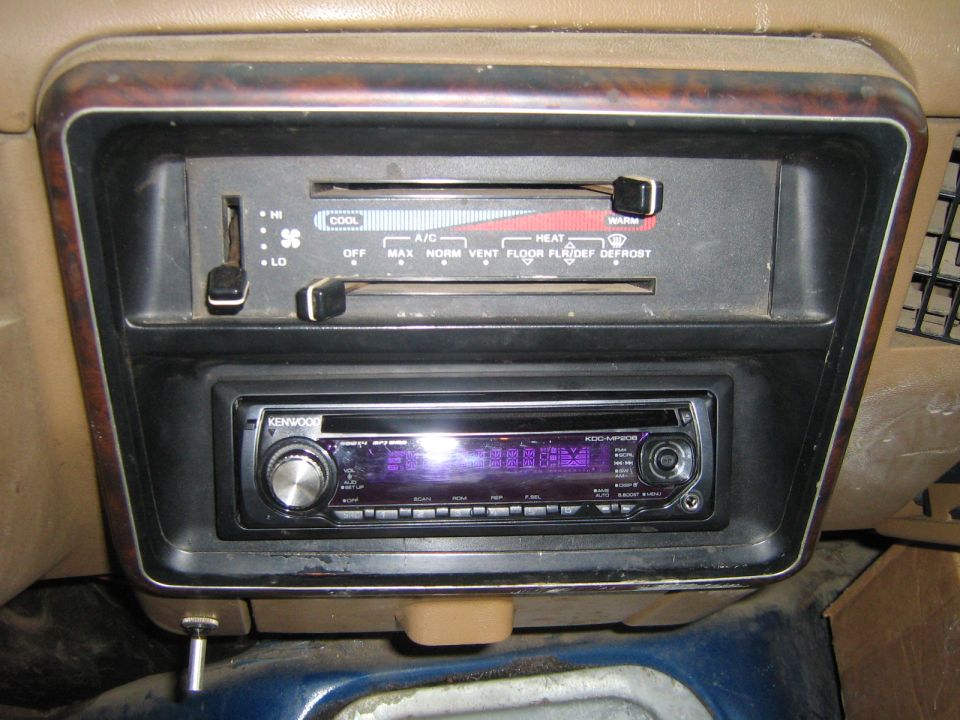 Car interior showing climate controls with HI/LO and COOL/HEAT settings, and an aftermarket Kenwood stereo below