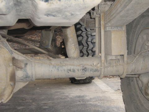 1990 Ford Bronco - Close-up of the rear suspension and axle components of a vehicle.