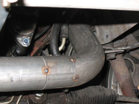 2001 Pontiac Trans Am - Close-up view of custom exhaust piping and engine bay components, with visible welds and suspension elements.
