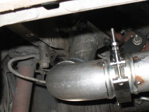 2001 Pontiac Trans Am - Close-up view of a custom exhaust pipe installation, showing a clamp and a sensor wire attached.