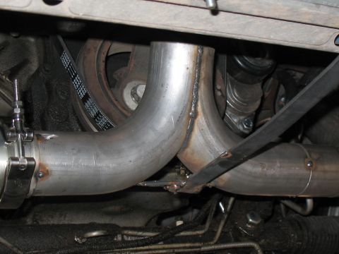 2001 Pontiac Trans Am - Custom exhaust piping and serpentine belt assembly under a vehicle.