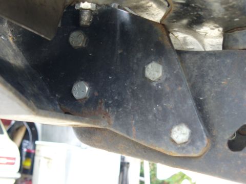 1978 Ford Bronco - Close-up view of a vehicle's frame bracket and mounting bolts.