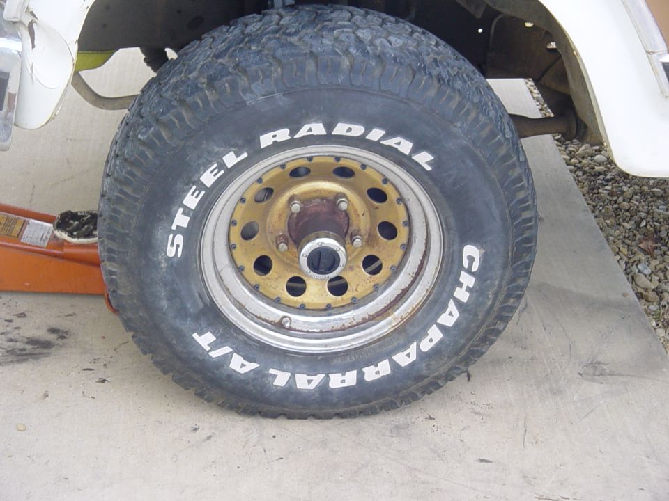Close-up of a Chaparral A/T steel radial tire on a gold-colored wheel