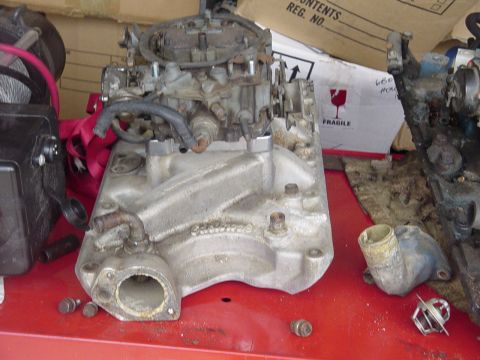 1982 Ford Bronco - Close-up of an engine intake manifold and carburetor assembly, likely for a V8 engine.