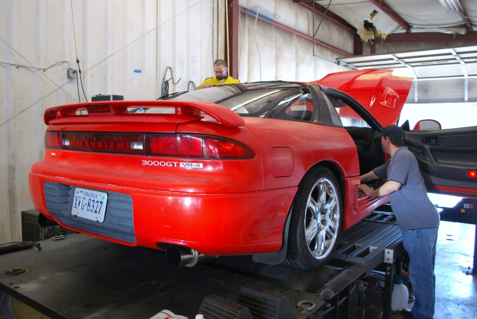 Red 1991 Mitsubishi 3000GT VR-4 on a lift with hood and door open