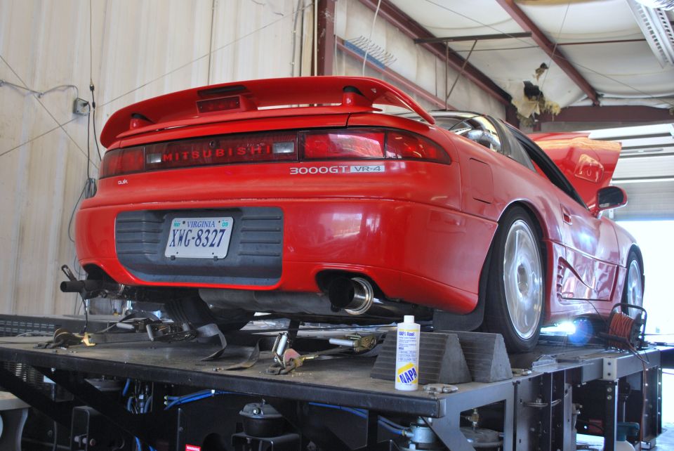 Red 1991 Mitsubishi 3000GT VR-4 on a dynamometer, rear view. License plate XWG-8327