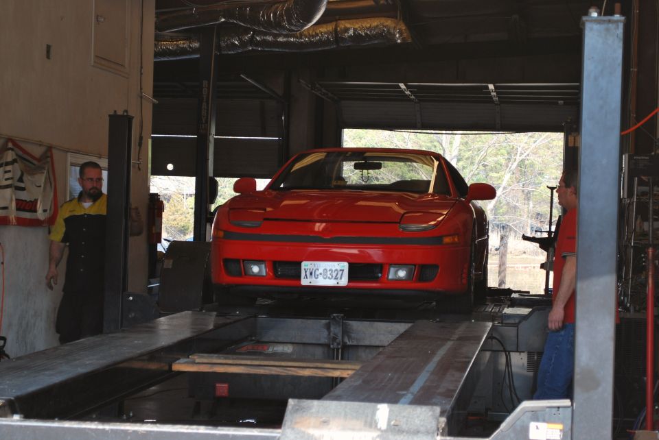 Red 1991 Mitsubishi 3000GT front view on a car lift