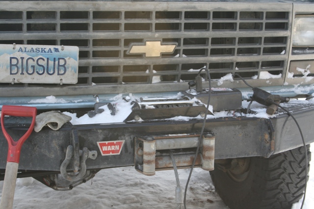 1990 Chevrolet Suburban front bumper with WARN winch and shovel.